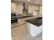 Modern kitchen showcasing stainless steel appliances, speckled black granite counters, and white cabinets at 31274 N 130Th Ave, Peoria, AZ 85383