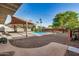 Backyard featuring desert landscaping, pool, and shed at 317 E Belmont Ave, Phoenix, AZ 85020