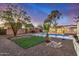The backyard has desert landscaping, small pool, and a patch of artificial turf at 317 E Belmont Ave, Phoenix, AZ 85020