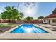 Backyard swimming pool shimmers in the sunlight with a bright blue color and cool concrete surroundings at 317 E Belmont Ave, Phoenix, AZ 85020