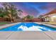 Backyard pool with concrete surround and view of home at 317 E Belmont Ave, Phoenix, AZ 85020