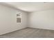 Bedroom with neutral carpet and walls, with a window letting in natural light at 35815 N King Ln, San Tan Valley, AZ 85140