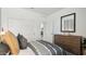 Neutral toned bedroom features a grey and white comforter, dresser, and closet at 35815 N King Ln, San Tan Valley, AZ 85140