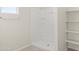 Walk-in shower with shelves, a modern design, and natural light at 35815 N King Ln, San Tan Valley, AZ 85140
