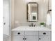 Bathroom featuring a vanity with a white countertop, sink, dark bronze faucet, mirror and dark hardware on cabinets at 3648 E Fargo St, Mesa, AZ 85205