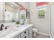 Bright bathroom features a double sink vanity with a large mirror, patterned tile floor, and a window for natural light at 3648 E Fargo St, Mesa, AZ 85205