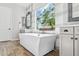 The modern bathroom features a freestanding tub under a window with views of the outside at 3648 E Fargo St, Mesa, AZ 85205