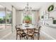 Cozy dining room with a round table, decorative chandelier, and a view of the outdoor pool and patio at 3648 E Fargo St, Mesa, AZ 85205