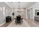 Dining room showcasing a modern chandelier, hardwood floors, and neutral tones at 3648 E Fargo St, Mesa, AZ 85205