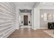 Elegant entryway featuring wood floors, accent wall, and views into the home at 3648 E Fargo St, Mesa, AZ 85205