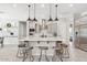 Open kitchen featuring stainless steel appliances, quartz countertops and a large island with barstool seating at 3648 E Fargo St, Mesa, AZ 85205