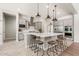 Open kitchen featuring a large island with seating, stainless steel appliances and tile flooring throughout at 3648 E Fargo St, Mesa, AZ 85205