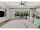Bright living room with sliding glass doors, built-in shelving, and a comfortable sofa at 3648 E Fargo St, Mesa, AZ 85205