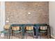Multi use space has cool brick wall, three desk spaces, and three retro style chairs at 3648 E Fargo St, Mesa, AZ 85205
