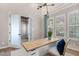 Light-filled home office with custom lighting, wood desktop, and frosted glass doors at 3648 E Fargo St, Mesa, AZ 85205
