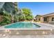 Sparkling pool is surrounded by a travertine deck, lush landscaping, and desert foliage at 3648 E Fargo St, Mesa, AZ 85205