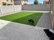 Backyard featuring a well-maintained turf lawn, block fence, and a comfortable paved area for leisure at 38086 W Isabella Ln, Maricopa, AZ 85138