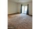Bright bedroom featuring sliding glass doors and neutral walls allowing ample natural light to flow through at 38086 W Isabella Ln, Maricopa, AZ 85138