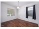 Cozy dining room with hardwood floors, natural lighting, and neutral paint, ready for personal touches at 38086 W Isabella Ln, Maricopa, AZ 85138