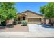Charming single-story home featuring a two-car garage, neutral exterior, and low maintenance landscaping at 38086 W Isabella Ln, Maricopa, AZ 85138