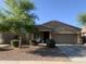 Charming single-story home with a two-car garage and low maintenance desert landscaping at 38086 W Isabella Ln, Maricopa, AZ 85138