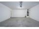 Spacious garage with modern door opener, water heater, and ample room for parking and storage at 38086 W Isabella Ln, Maricopa, AZ 85138