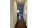 Inviting hallway that leads to the living area and features sleek hard surface floors and neutral walls at 38086 W Isabella Ln, Maricopa, AZ 85138