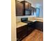 Functional kitchen showcasing dark cabinetry, modern black appliances, and durable counter tops at 38086 W Isabella Ln, Maricopa, AZ 85138