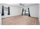 Neutral living room featuring sliding glass doors and a ceiling fan at 38086 W Isabella Ln, Maricopa, AZ 85138
