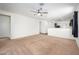 Living room featuring an open floor plan with neutral walls and carpet at 38086 W Isabella Ln, Maricopa, AZ 85138