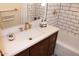 The updated bathroom features stylish tile, modern fixtures, and a wood vanity at 3942 N 38Th St, Phoenix, AZ 85018