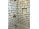 Bathroom shower with stylish subway tile, a bronze faucet, and a convenient recessed shelf at 3942 N 38Th St, Phoenix, AZ 85018