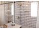 The updated bathroom features subway tile, modern fixtures, and a tub with shower at 3942 N 38Th St, Phoenix, AZ 85018