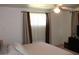 Neutral bedroom features a ceiling fan and window at 3942 N 38Th St, Phoenix, AZ 85018