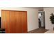A bedroom with a large closet with wooden doors and an opening to an adjacent room at 3942 N 38Th St, Phoenix, AZ 85018