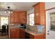Kitchen with wooden cabinets, tile countertops, stainless steel sink, and adjacent dining area at 3942 N 38Th St, Phoenix, AZ 85018