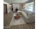 Spacious living room featuring wood flooring and a comfortable sectional sofa at 3942 N 38Th St, Phoenix, AZ 85018