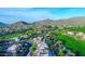Gorgeous aerial view of a golf course community showcasing luxurious homes, lush landscaping, and scenic mountain views on a sunny day at 4050 N Terra Mesa Cir, Mesa, AZ 85207