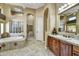 Bathroom featuring a jetted tub, a separate tiled shower, and warm neutral decor at 4050 N Terra Mesa Cir, Mesa, AZ 85207