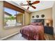 Inviting bedroom features a ceiling fan, and a large window with views of the private backyard at 4050 N Terra Mesa Cir, Mesa, AZ 85207