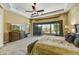 Well-lit main bedroom with a large bed, a ceiling fan, and a beautiful view of the outside at 4050 N Terra Mesa Cir, Mesa, AZ 85207