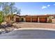 Charming home featuring a four-car garage, desert landscaping, and brick paved driveway at 4050 N Terra Mesa Cir, Mesa, AZ 85207