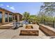 Cozy outdoor area features a stone fire pit, seating, and a refreshing view of the pool at 4050 N Terra Mesa Cir, Mesa, AZ 85207