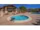 Relaxing hot tub surrounded by lounge seating and community pool provide the perfect outdoor oasis at 4050 N Terra Mesa Cir, Mesa, AZ 85207