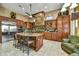 Gourmet kitchen featuring a large center island, wood cabinets, and stainless appliances at 4050 N Terra Mesa Cir, Mesa, AZ 85207