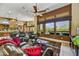 Spacious living room featuring leather furniture, large windows with views, and access to the kitchen and dining area at 4050 N Terra Mesa Cir, Mesa, AZ 85207