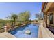 Relaxing pool with a stone waterfall feature and mature desert landscaping offers backyard tranquility at 4050 N Terra Mesa Cir, Mesa, AZ 85207