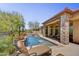 Inviting backyard oasis with pool, spa, covered patio, lounge chairs, and desert landscaping at 4050 N Terra Mesa Cir, Mesa, AZ 85207