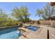 Backyard with pool and spa with stone accents and desert landscape offers serene privacy at 4050 N Terra Mesa Cir, Mesa, AZ 85207