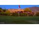 Picturesque restaurant patio overlooking a lush green golf course, illuminated with string lights, and a vibrant outdoor setting at 4050 N Terra Mesa Cir, Mesa, AZ 85207